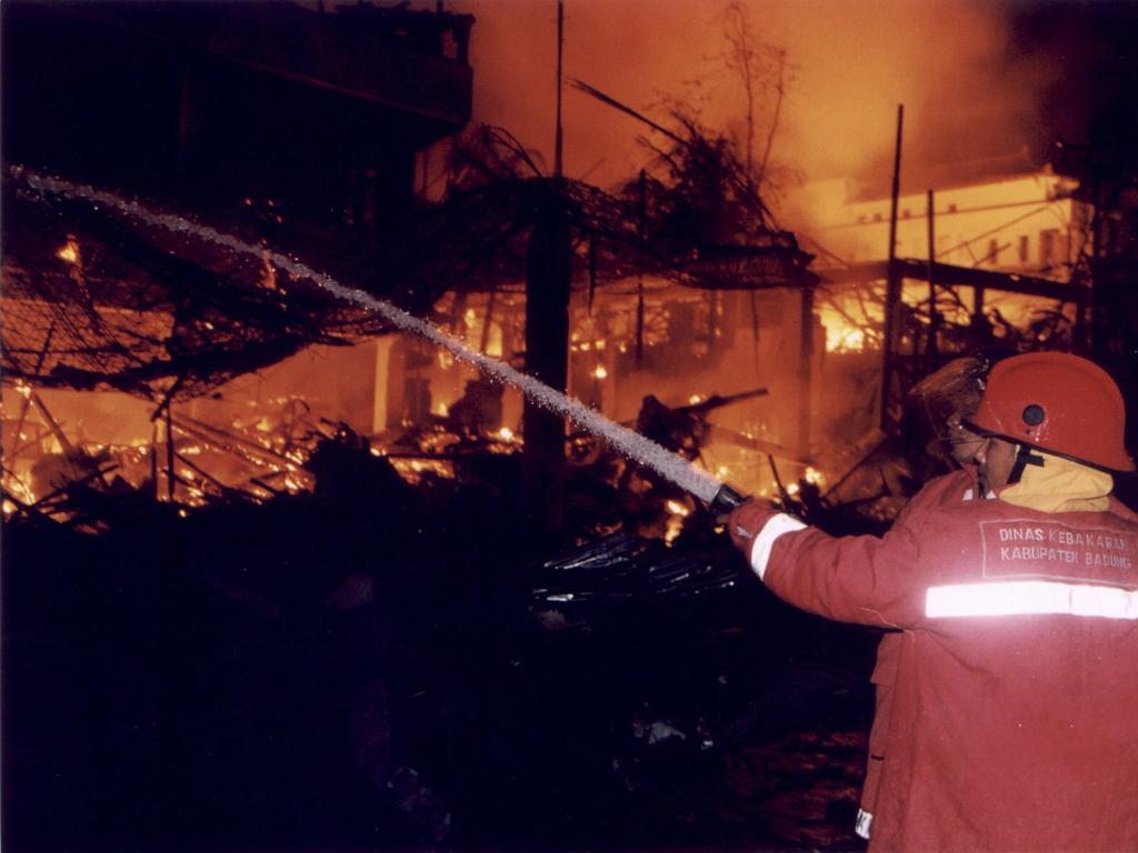 Firemen attempt to extinguish the blaze ignited by a bomb blast at the Sari nightclub on Kuta Beach, on the island of Bali in 2002. Picture: AP