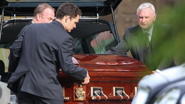 Joe Acquaro's coffin is taken into the church. Picture: Ian Currie