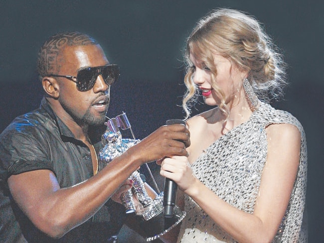 Kanye West takes the microphone from singer Taylor Swift as she accepts the "Best Female Video" award during the MTV Video Music Awards in New York. Picture: AP