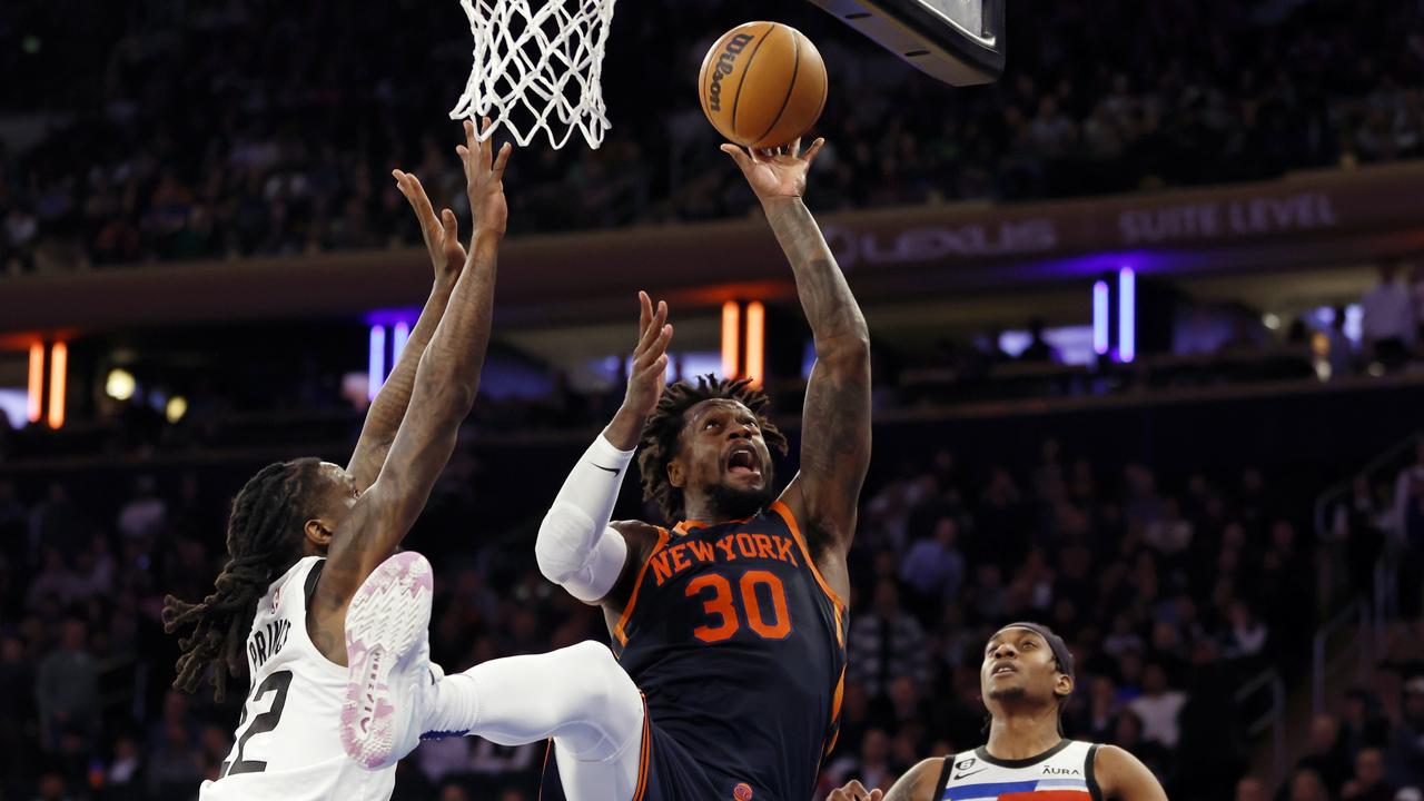 NEW YORK, NEW YORK – MARCH 20: Julius Randle #30 of the New York Knicks goes to the basket as Jaden McDaniels #3 and Taurean Prince #12 of the Minnesota Timberwolves defend during the second half at Madison Square Garden on March 20, 2023 in New York City. The Timberwolves won 140-134. NOTE TO USER: User expressly acknowledges and agrees that, by downloading and/or using this photograph, User is consenting to the terms and conditions of the Getty Images License Agreement. (Photo by Sarah Stier/Getty Images)