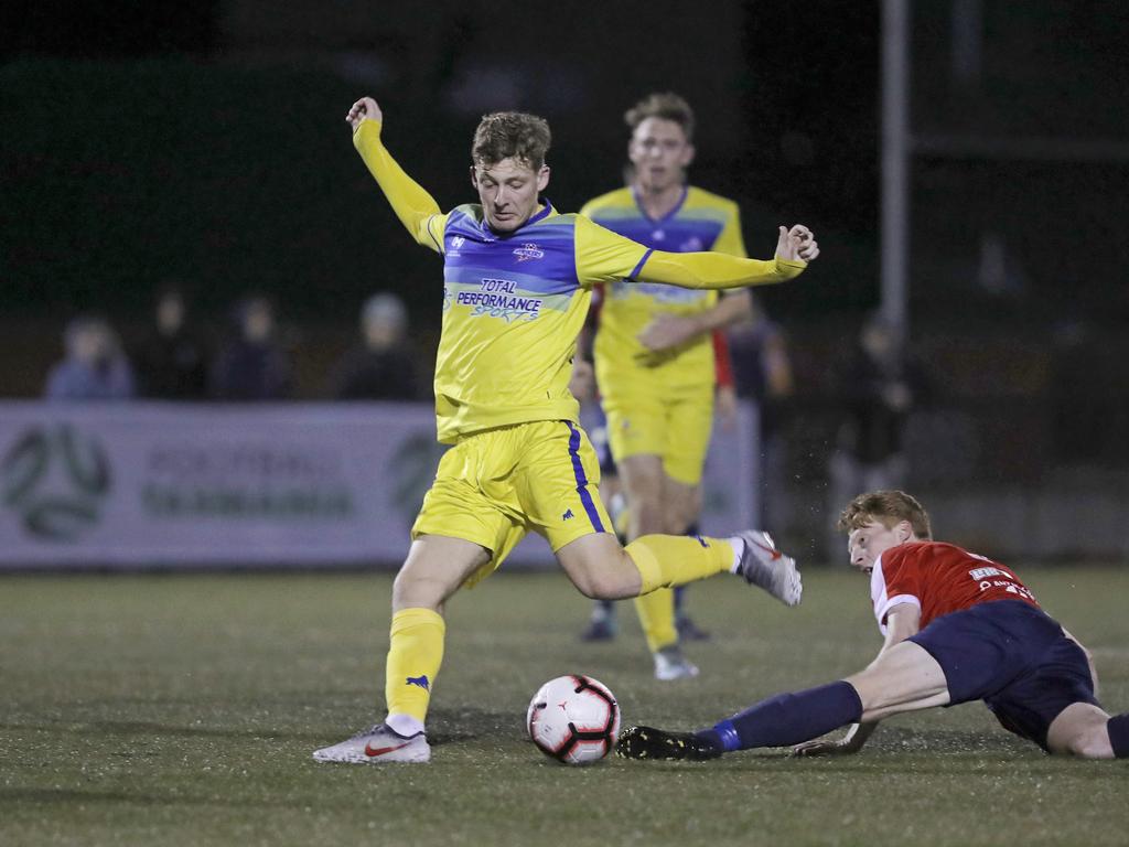 Lokoseljac Cup Final at KGV. Devonport Strikers versus South Hobart. Devonport's Max Fitzgerald takes on South Hobart's Adam Gorrie and shoots at goal. Picture: PATRICK GEE