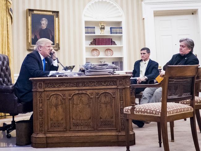 Then National Security Advisor Michael Flynn and Senior Counselor to the President Steve Bannon, sit nearby as United States President Donald Trump speaks on the phone with Prime Minister of Australia, Malcolm Turnbull in the Oval Office on January 28, 2017. Picture: Pete Marovich/Consolidated News