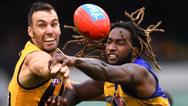 Jonathon Ceglar of the Hawks and Nic Naitanui of the Eagles compete in the ruck.