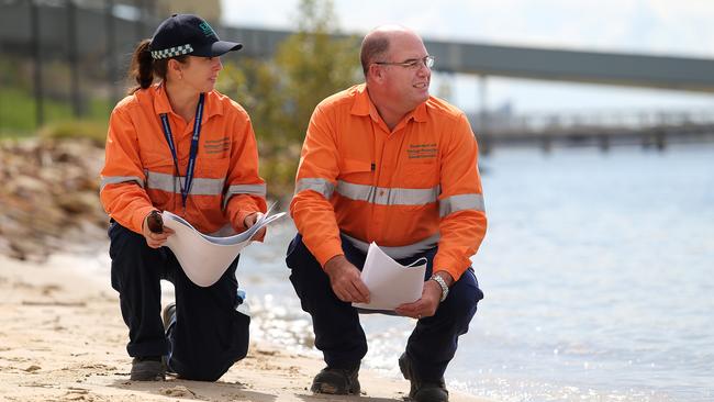 Environmental officers inspect the mouth of the Brisbane River soon after the spill.