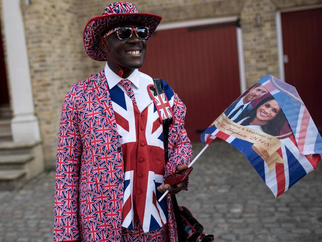 Royal fan Joseph Afrane waits near the proposed route of the carriage procession two days before the Royal wedding. Picture: AFP