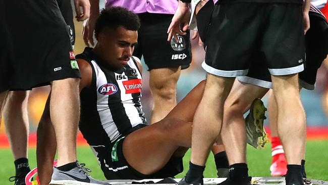 Isaac Quaynor remained calm as trainers tended to his injured leg. Picture: AFL Photos