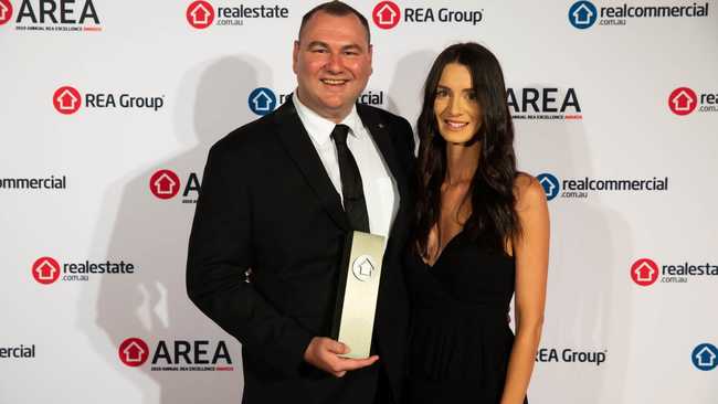 Mark McGill has been highlighted as an industry trailblazer after he picked up a perfect score and national award at the realestate.com.au AREAs. Pictured with sales associate Alana Luchetta.