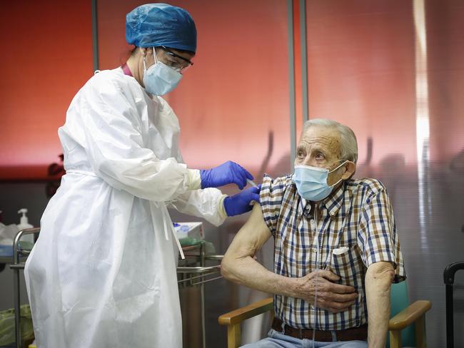 Nicanor, aged 72, receives one of Spain's first Pfizer BioNTech Covid-19 vaccines in the Vallecas Elderly Centre in Madrid.