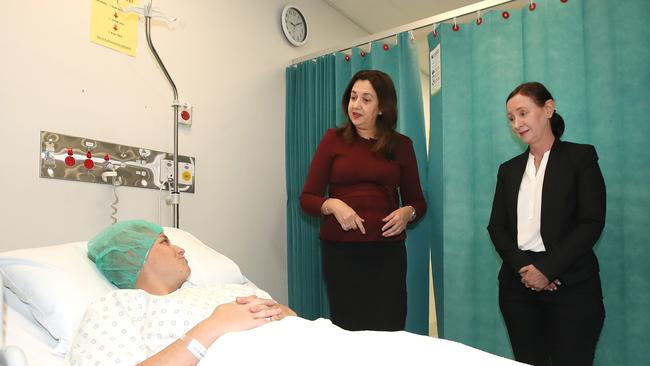 Queensland Premier Annastacia Palaszczuk and Health Minister Yvette D'Ath speak with patient Caitlin Sippel at the Mater Private hospital in Springfield, after the government announced it would deliver 174 new public hospital beds to the hospital. Picture: NCA NewsWire / Jono Searle