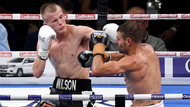 Liam Wilson and Brent Rice trade blows during the Australian Featherweight Title fight at Suncorp Stadium. Picture: Bradley Kanaris/Getty Images