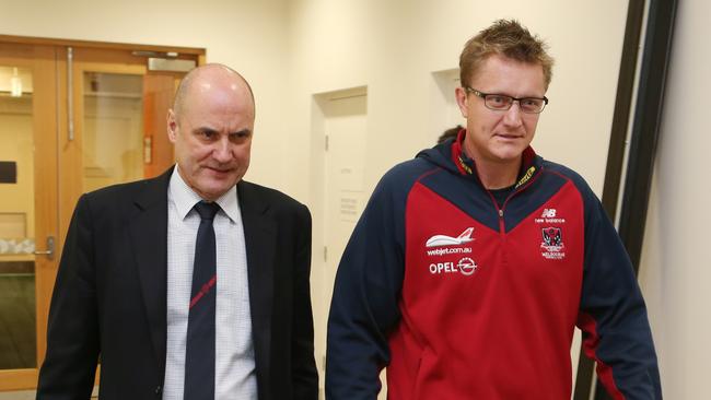 CEO Peter Jackson and Melbourne Demons  AFL football coach Mark Neeld arrive at a press conference in Melbourne where it has been announced that Mark Neeld has been sacked as the club coach. Monday, June 17, 2013. The sacking of Neeld follows a poor season by Melbourne where they have only won one game for the season. (AAP Image/ David Crosling) NO ARCHIVING