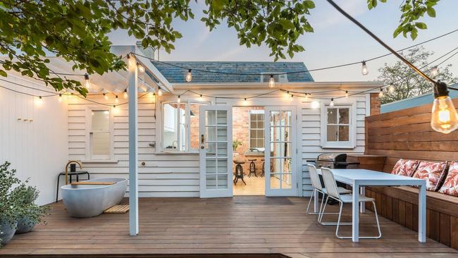 A lavish outdoor bath and built-in seating a luxury additions in the back of the home.