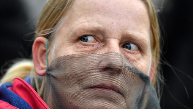 A demonstrator covers her face with a piece of tulle during a Berlin protest against measures to limit the spread of coronavirus. Picture: AFP