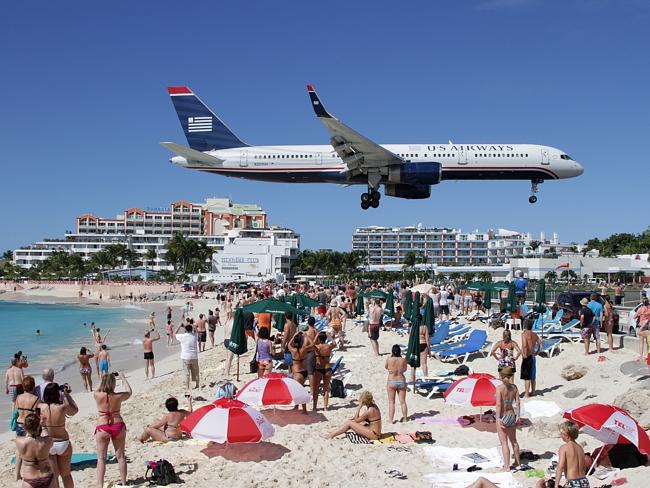 US Airways Boeing 757 flies over the heads of sunseekers at St Maarten. Picture: AirTeamImages