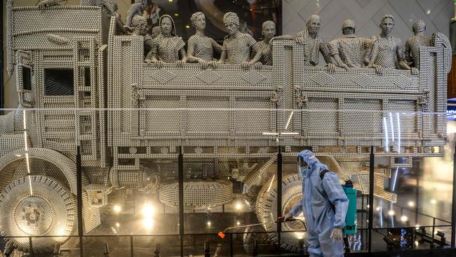 Cleaning staff wearing personal protective equipment (PPE) disinfectant the High Street Phoenix mall in Mumbai on Thursday. Picture: AFP