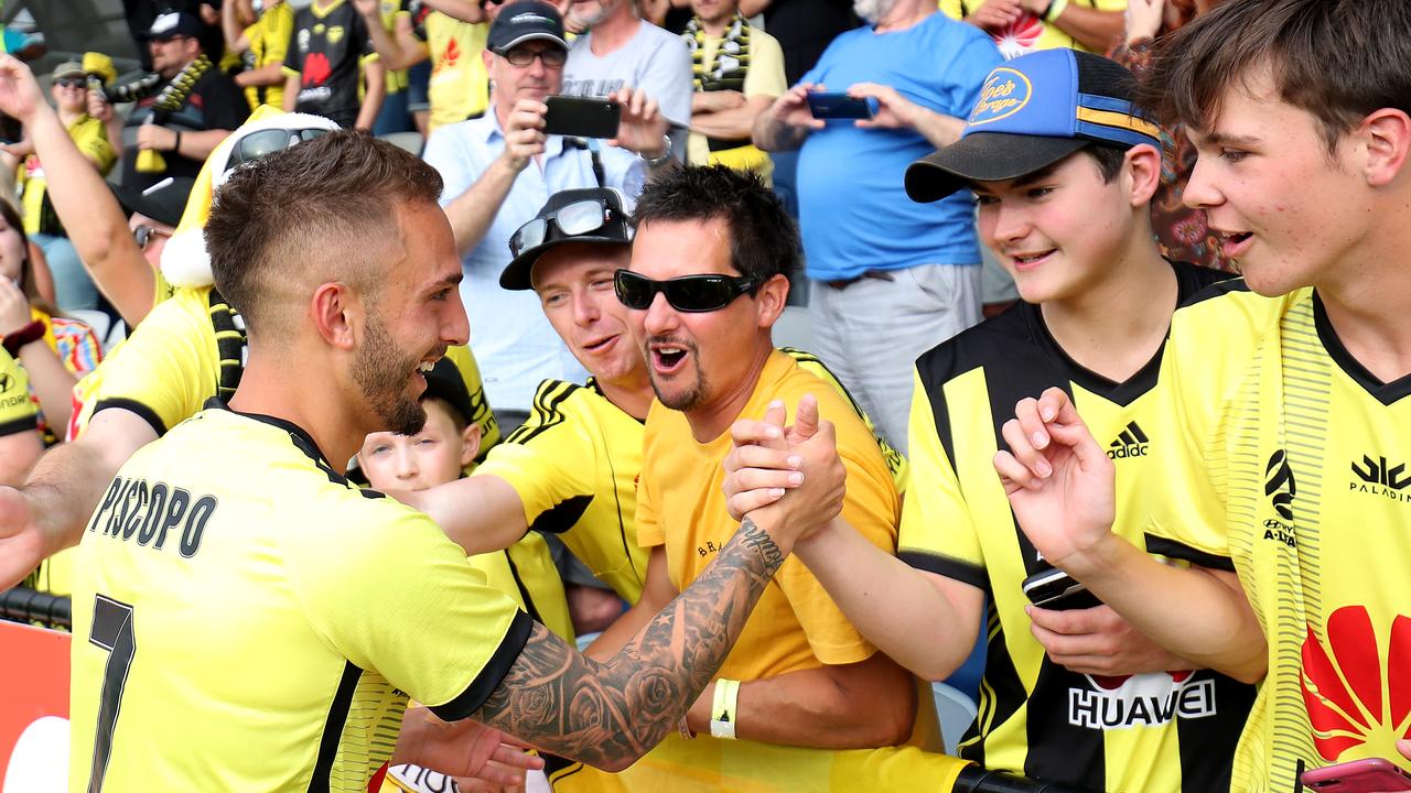 Wellington Phoenix fans celebrate with A-League player Reno Piscopo.