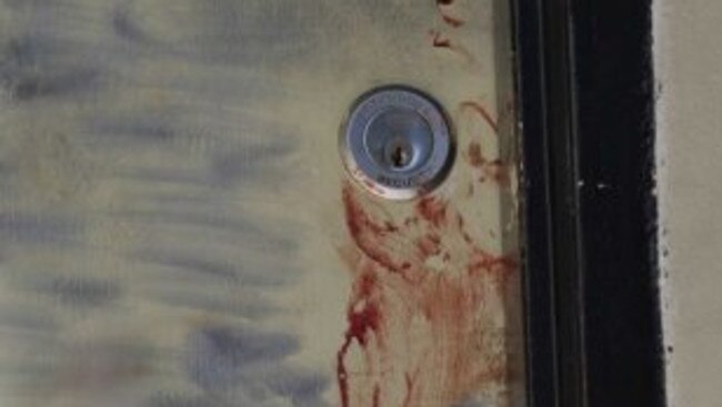 Smears of blood on the share house door. Picture. ABC