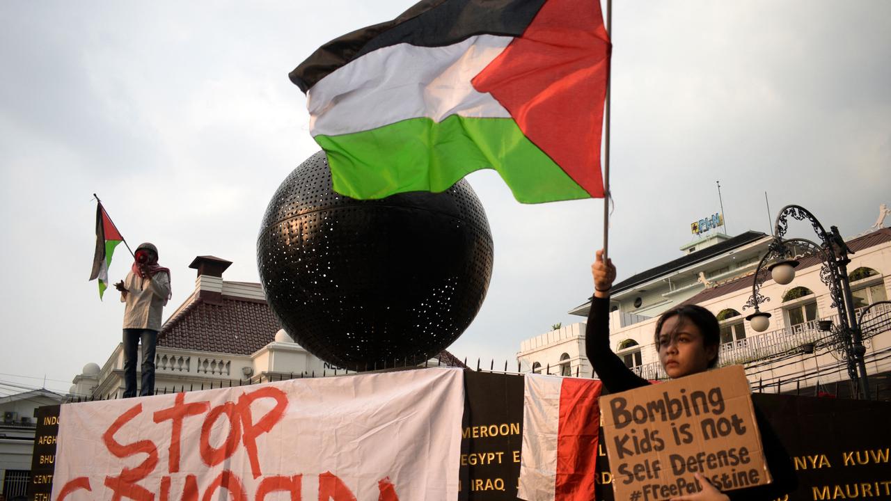 Pro-Palestinian activists perform at the Palestine Walk Monument during a protest against Israel's actions in Gaza, in Bandung on May 8, 2024. (Photo by Timur MATAHARI / AFP)