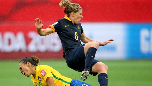 Marta of Brazil is given a yellow card on this tackle as Elise Kellond-Knight of Australia falls during the FIFA Women's World Cup 2015 round of 16 match between Brazil and Australia.