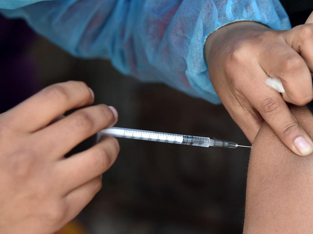 A boy is inoculated against coronavirus in La Paz as cases surge worldwide. Picture: AFP