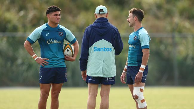 Wallabies coach Joe Schmidt talks with Noah Lolesio and Nic White in Brisbane.Picture: Chris Hyde/Getty Images