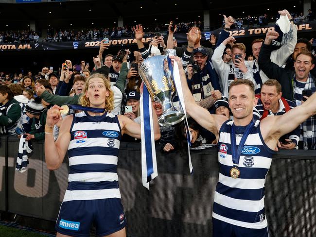 Sam De Koning (left) and Joel Selwood celebrate their first and fourth premierships. Picture: Michael Willson