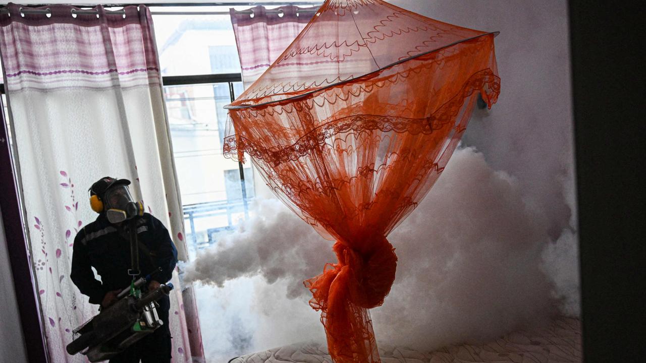 A worker fumigates a house against mosquito to prevent the spread of dengue fever in a neighbourhood in Piura, northern Peru. Picture: ERNESTO BENAVIDES / AFP.