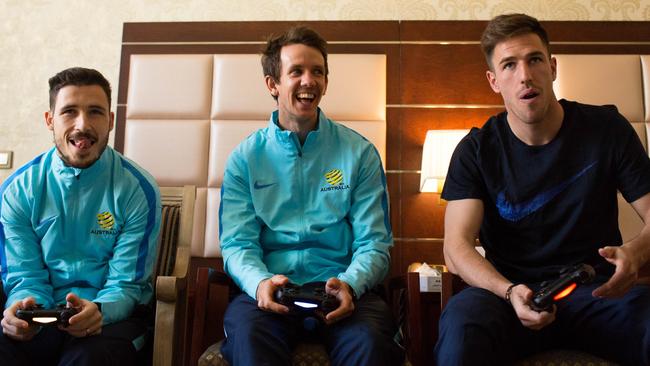 The FFA has announced an esports league called the e-League, with every A-League club to have gamers representing them. Here, Socceroos Mathew Leckie, Robbie Kruse and Milos Degenek play the FIFA video game.
