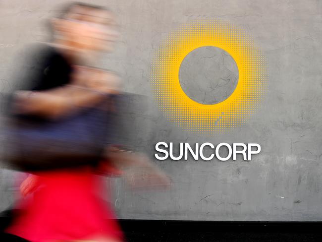 A woman walks past a Suncorp bank office in Brisbane, Thursday, October 4, 2018. (AAP Image/Dave Hunt) NO ARCHIVING