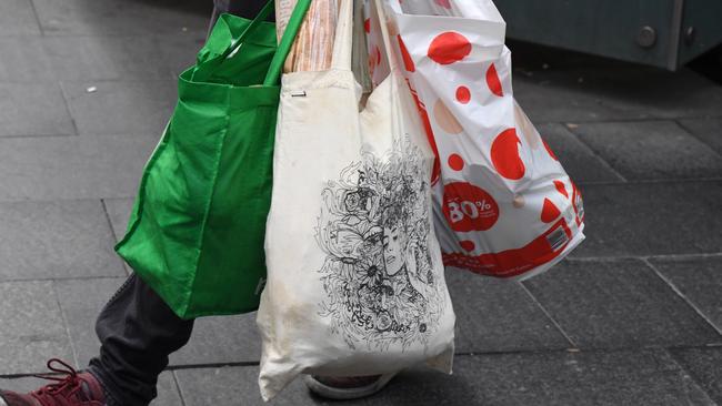 A shopper is seen carrying bags at a Coles Sydney CBD store, Sydney, Monday, July 2, 2018. Woolworths says it will hand out free reusable bags for the next 10 days as its customers get used to its ban on single-use plastic bags. Woolies stores in NSW, Queensland, Victoria and Western Australia stopped providing free single-use plastic bags on June 20. (AAP Image/Peter RAE) NO ARCHIVING