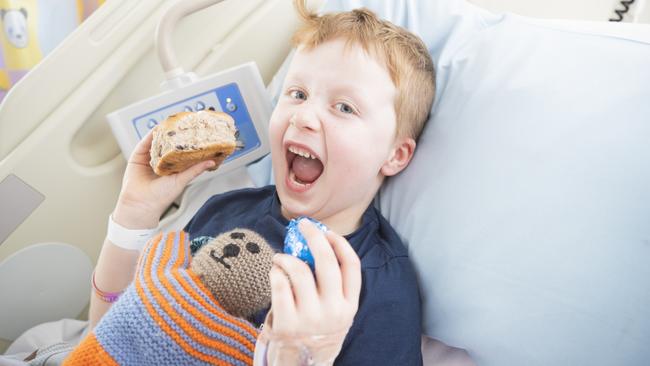 Hayden Duncan, 6, from Melbourne, tucks into some Easter treats.  Picture: RICHARD JUPE