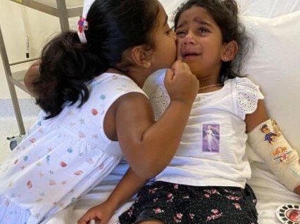 Tharnicaa with her sister Kopika in hospital on Christmas Island the day before an emergency evacuation to Perth. Picture: Supplied