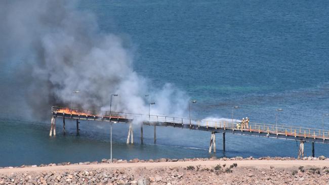 Firefighters putting out a blaze on the Whyalla jetty. Picture: Josh Berkett