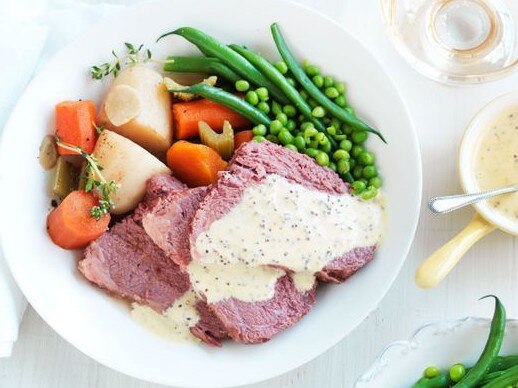 Slow cooker corned beef with vegetables and mustard sauce.