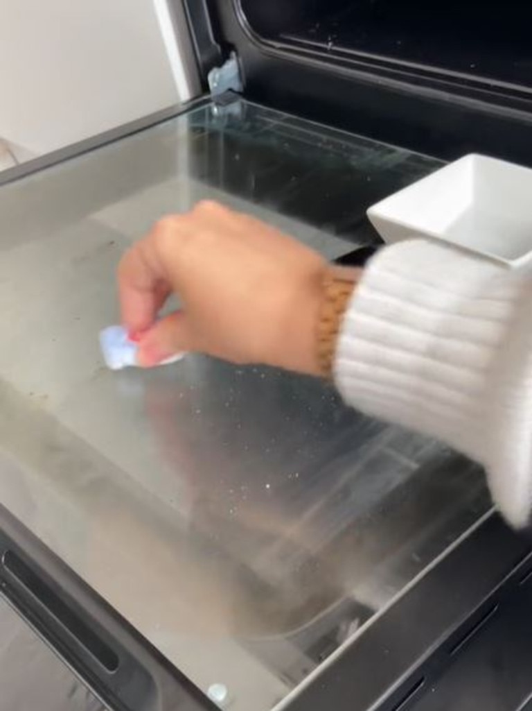 Placing a scouring pad in a mix of water and a dishwashing tablet could be all you need to fix your oven. Picture: stephshome, TikTok