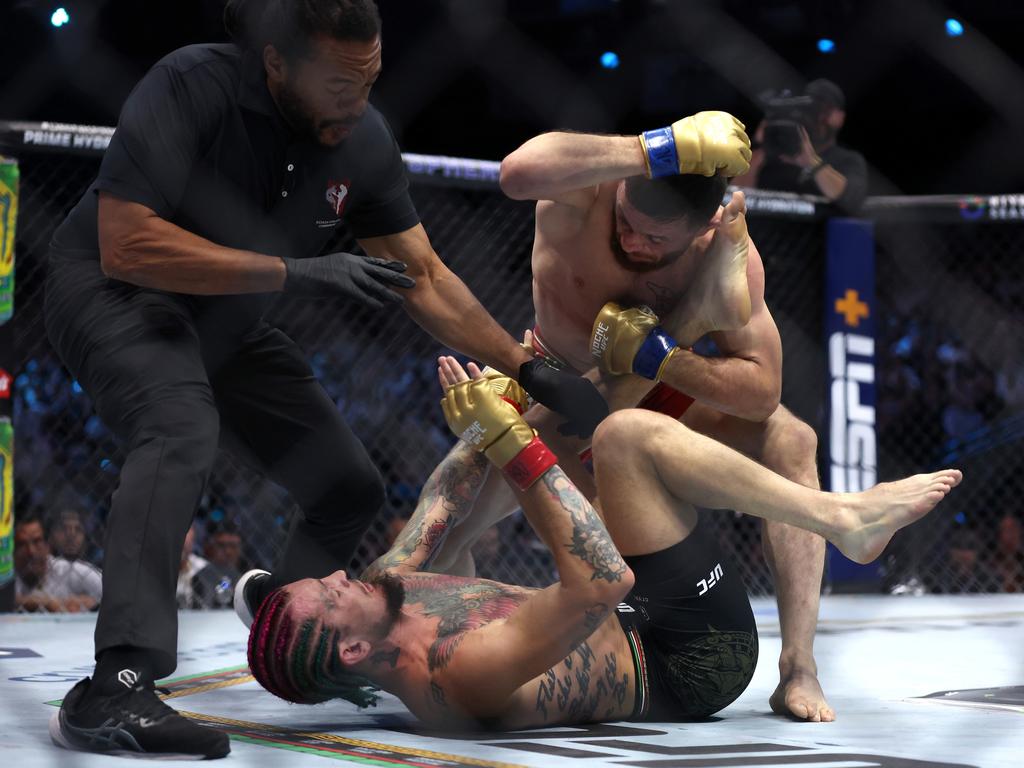 Referee Herb Dean separates Sean O’Malley and Merab Dvalishvili during their bantamweight title bout. Picture: Getty Images