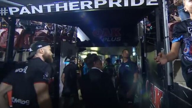 Rabbitohs players leaving the field react after a fan allegedly shouted out a racial slur.