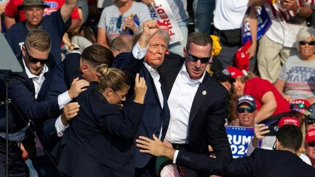 Donald Trump is escorted off stage. Picture: Rebecca Droke/AFP