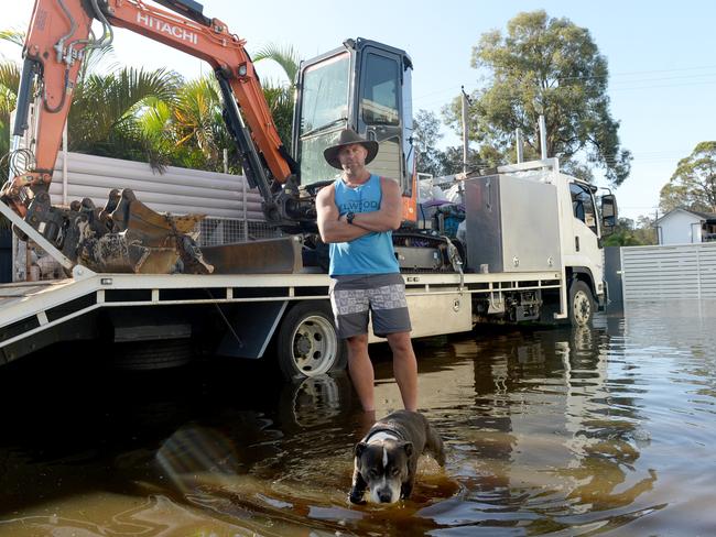 Ben Weber, of Chittaway Bay, took an excavator onto North Entrance Beach to help hundreds of people unblock The Entrance Channel. Picture: Jeremy Piper