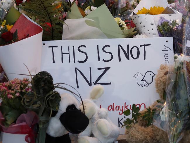 FILE - In this March 16, 2019, file photo, flowers lay at a memorial near the Masjid Al Noor mosque for victims in March 15 shooting in Christchurch, New Zealand. New Zealanders are debating the limits of free speech after their chief censor banned a 74-page manifesto written by a man accused of massacring 50 people at two mosques. (AP Photo/Vincent Yu, File)