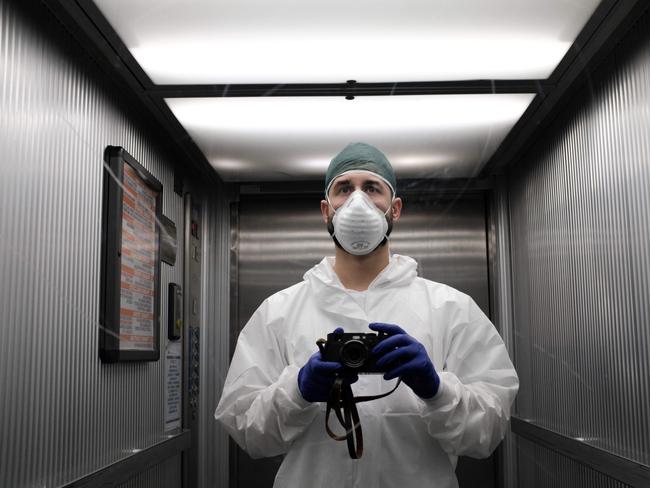 Italian nurse Paolo Miranda takes a self portrait in an elevator's mirror as he goes to start his shift at the Cremona hospital, southeast of Milan. Picture: AFP