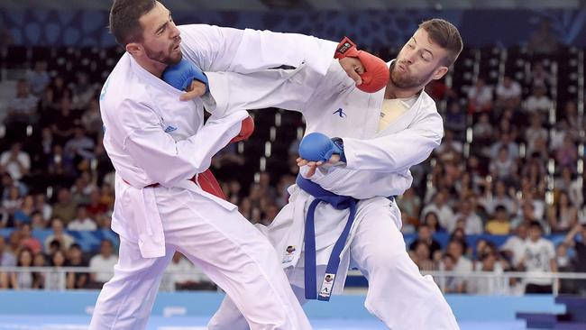 Azerbaijan's Aykhan Mamayev (L) competes against Greece's Michail Georgios Tzanos during the Men's Karate Kumite -84kg, as part of the 2015 European Games in Baku on June 14, 2015. AFP PHOTO / TOBIAS SCHWARZ