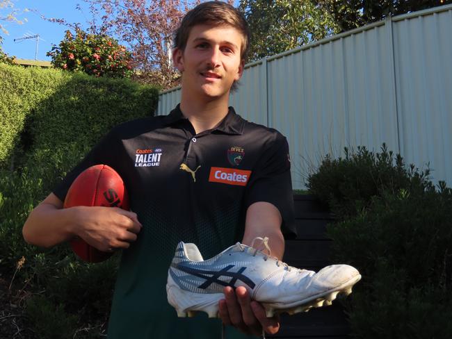 Tasmanian draft hopeful Oliver Dean with his oversized football boots. Picture: Jon Tuxworth