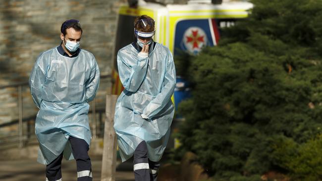 Paramedics are seen at the North Melbourne Public Housing tower complex. Picture: Getty Images