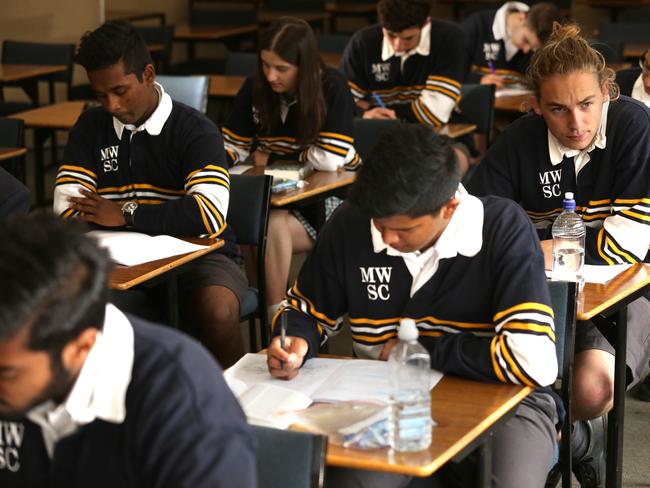 Students at Mount Waverley senior school after English VCE exam.Caleb Benson ponders his English paper.Picture: Stuart Milligan