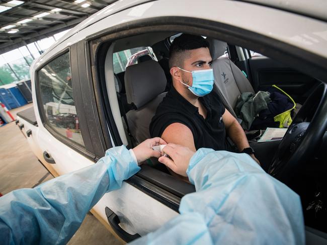 MELBOURNE, AUSTRALIA - AUGUST 09: A nurse administers the AstraZeneca COVID-19 vaccine at a drive through vaccination centre in Melton on August 09, 2021 in Melbourne, Australia. Eligible Victorians can book an appointment to attend the drive-through vaccination clinic and receive the Pfizer vaccine from today. The Australian-first clinic is expecting to administer 1500 vaccines per day. (Photo by Darrian Traynor/Getty Images)