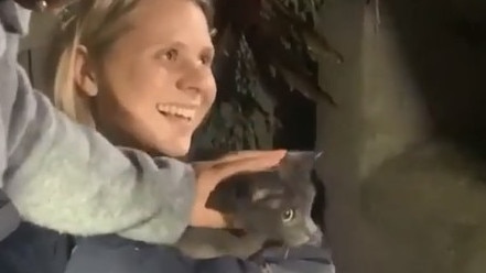 Alicia Dunstan holds Misty just moments after the cat was rescued from a stormwater pipe more than a metre under a back garden at Warriewood.