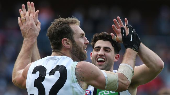 Travis Cloke of Collingwood celebrates kicking a goal with Alex Fasolo during the Round 16 AFL match between the Greater Western Sydney (GWS) Giants and the Collingwood Magpies at Spotless Stadium in Sydney, Saturday, July 9, 2016. (AAP Image/Craig Golding) NO ARCHIVING, EDITORIAL USE ONLY