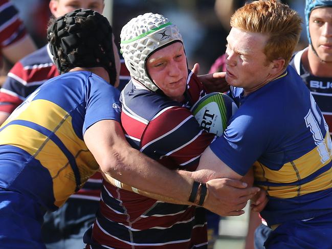 GPS rugby competition between The Southport School and Toowoomba Grammar at the main TSS rugby field.TSS half Lachlan McInnes crunched by the Grammar defence... Picture Glenn Hampson