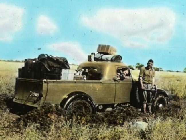 Sometimes it did rain in the Outback — locals turn out to help nurses in a bogged Australian Inland Mission ute back in 1951. Picture: John Flynn